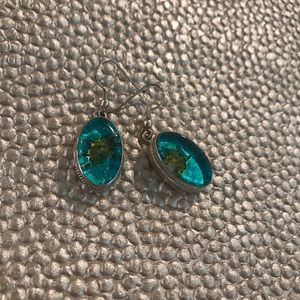 Silver dangle earrings with teal green design